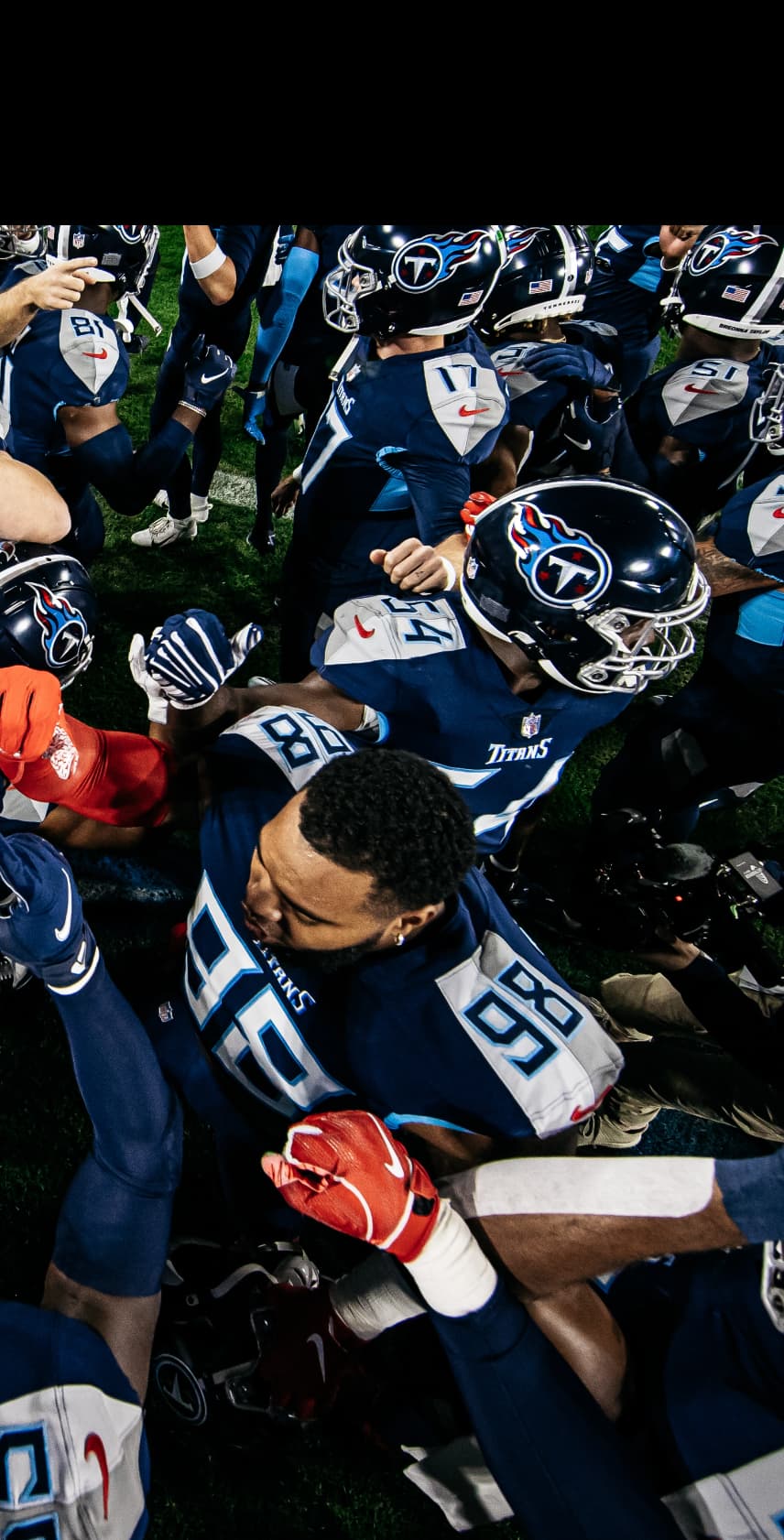 Tennessee Titans football team on the field celebrating with teammates